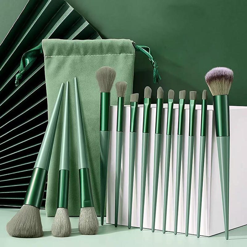 Professional green makeup brush set with storage pouch, featuring synthetic powder brushes, angular flat contour brushes, blending brushes, and precision eye makeup tools for flawless cosmetic application.