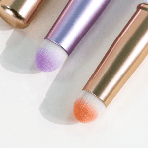 Portable lip brush with protective cap, synthetic bristles, and compact handle, designed for lipstick application, concealer touch-ups, and travel makeup use.