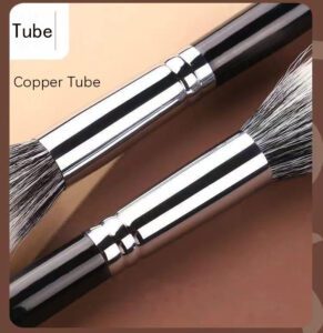 Professional stippling makeup brush with soft synthetic bristles, silver ferrule, and black handle, designed for blush, foundation, concealer, and cream makeup application.