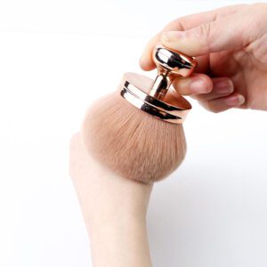 Large kabuki makeup brush with ultra-soft synthetic bristles and a rose gold handle, designed for self tanner, body makeup, bronzer, powder, and blending applications.