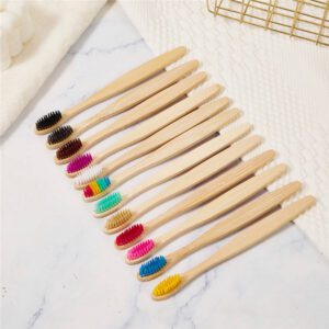 Pack of ten eco-friendly bamboo toothbrushes with colorful BPA-free bristles and recyclable kraft paper packaging, designed for adults and sustainable oral care