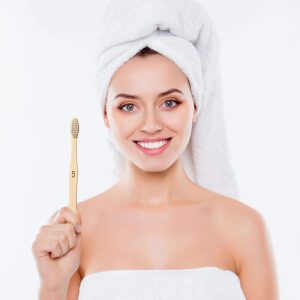 Set of bamboo toothbrushes with medium nylon bristles, natural wood handles, recyclable packaging, suitable for adult home use and sustainable oral care